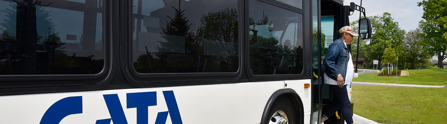 A woman exiting a CATA bus