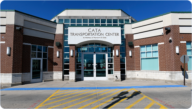 Front entrance of the CATA Transportation Center building with glass doors and signage.