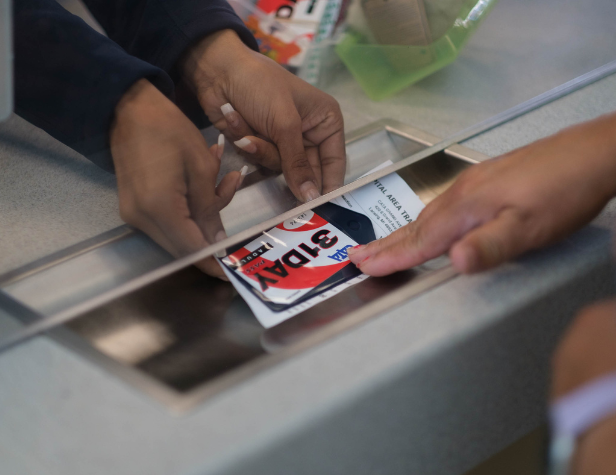 A customer service representative handing a pass to a customer