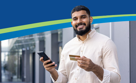 Man holding a card and smiling