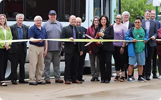 A group of people cutting a ribbon
